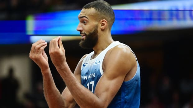Timberwolves center Rudy Gobert makes a "money" sign at the referees after committing a fould.